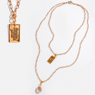 Katia Designs original lite necklace with antique gold finish, featuring a clover and engraved "Remember Who the F*ck You Are" pendant.