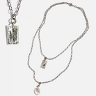 Katia Designs original Lite necklace in antique gold featuring a howlite clover and engraved "Remember Who the F*ck You Are" pendant.