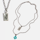 Katia Designs Remember Who the F*ck You Are Original Lite Necklace with antique gold finish and clover pendant.