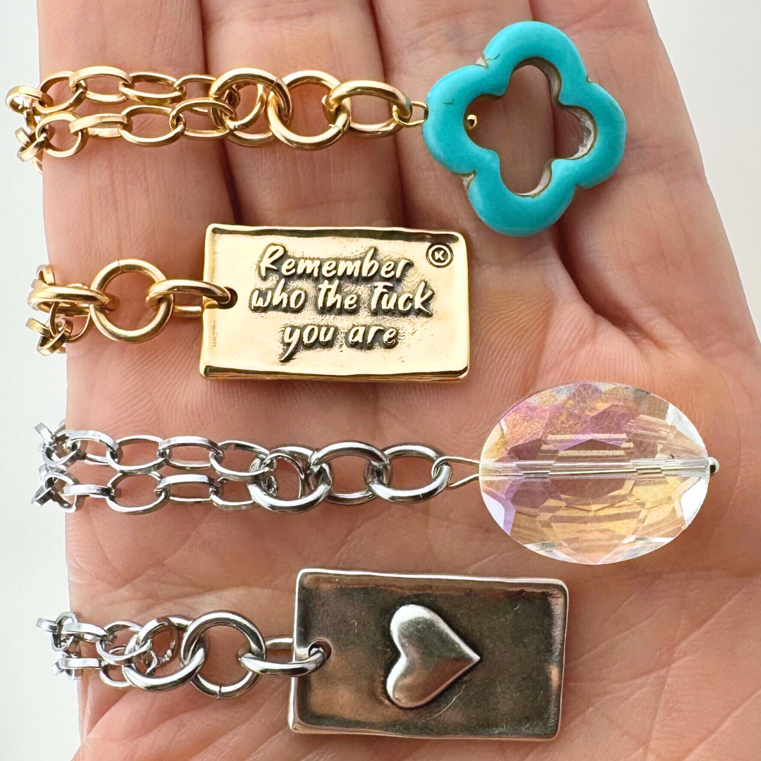Katia Designs original Lite necklace with antique gold finish, howlite and clover charm, engraved with "Remember Who the F*ck You Are"