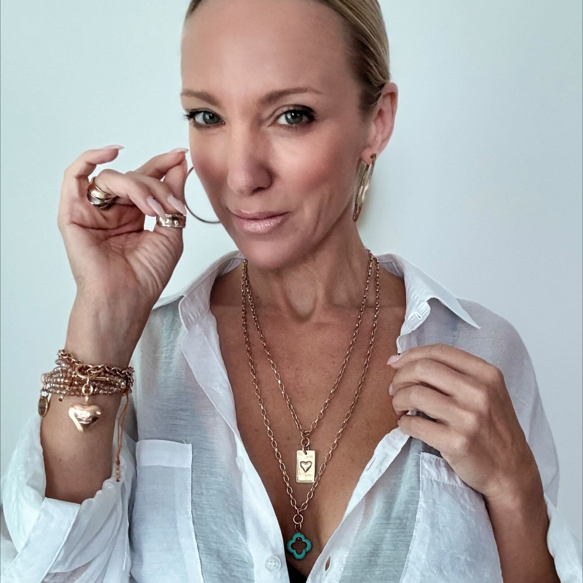 Katia Designs original lite necklace with antique gold finish, featuring a howlite clover and engraved message "Remember Who the F*ck You Are."