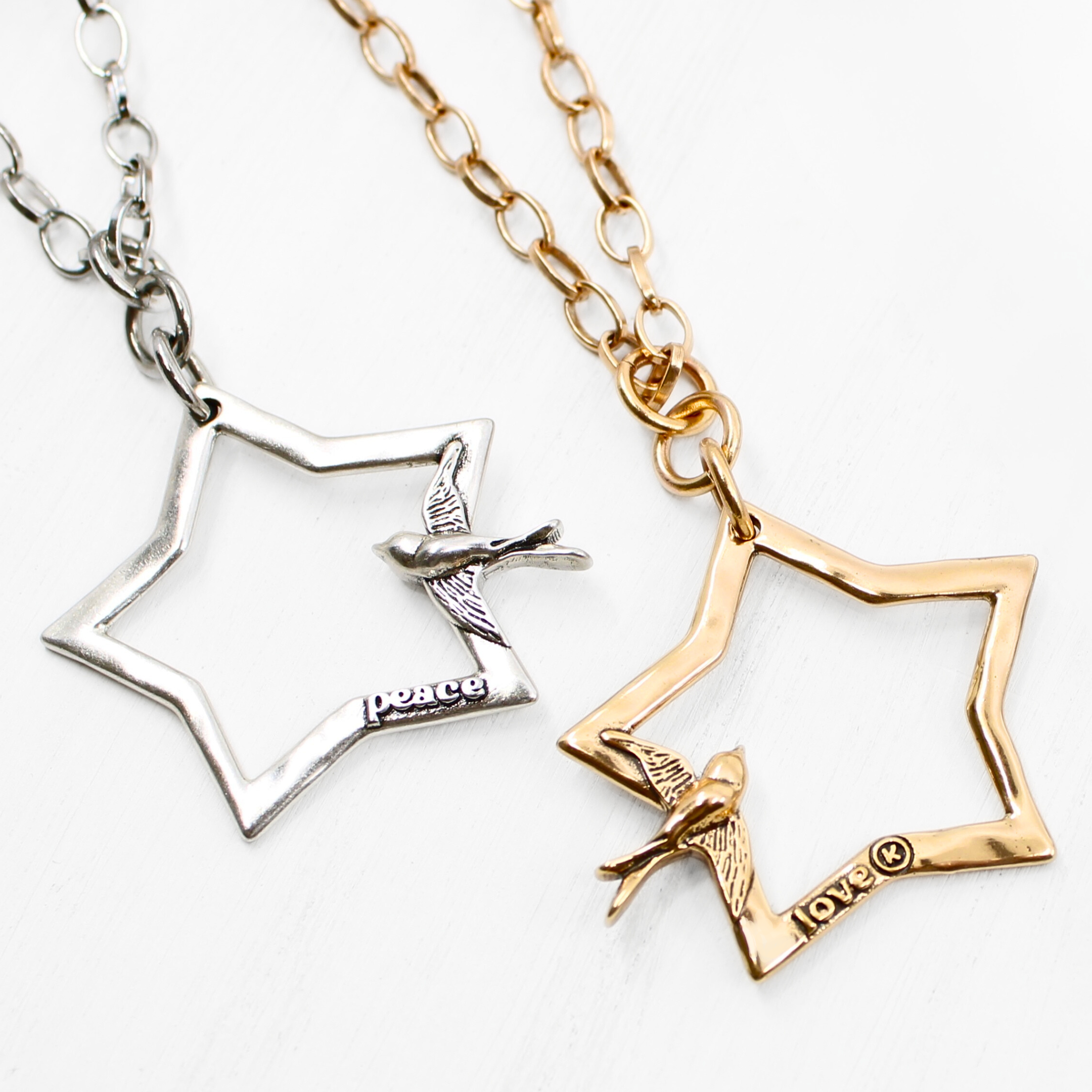 Katia Designs Peace & Love Star and Bird Original Lite Necklace in antique gold, featuring a star and bird pendant design.