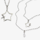 Katia Designs original Lite necklace featuring a gold-tone peace sign, star, and bird pendant with intricate detailing.