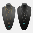 Katia Designs All Is Well Original Lite Necklace in antique gold with smoky crystal pendant, featuring a delicate chain and elegant design.