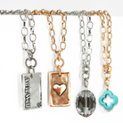 Katia Designs All Is Well Original Lite Necklace in antique gold with smoky crystal, featuring a delicate chain and elegant pendant.