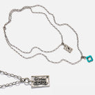 Katia Designs original Lite necklace with antique gold finish and smoky crystal, featuring "Take a Deep Breath and Let That Shit Go" pendant.