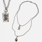Katia Designs original lite necklace with antique gold finish and smoky crystal, featuring the "Take a Deep Breath and Let That Shit Go" pendant.