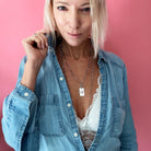 Katia Designs original lite necklace with antique gold finish and smoky crystal, featuring a "Take a Deep Breath and Let That Shit Go" pendant.
