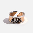 Katia Designs Just Breathe Remember adjustable ring with engraved text and simple band design on a white background.