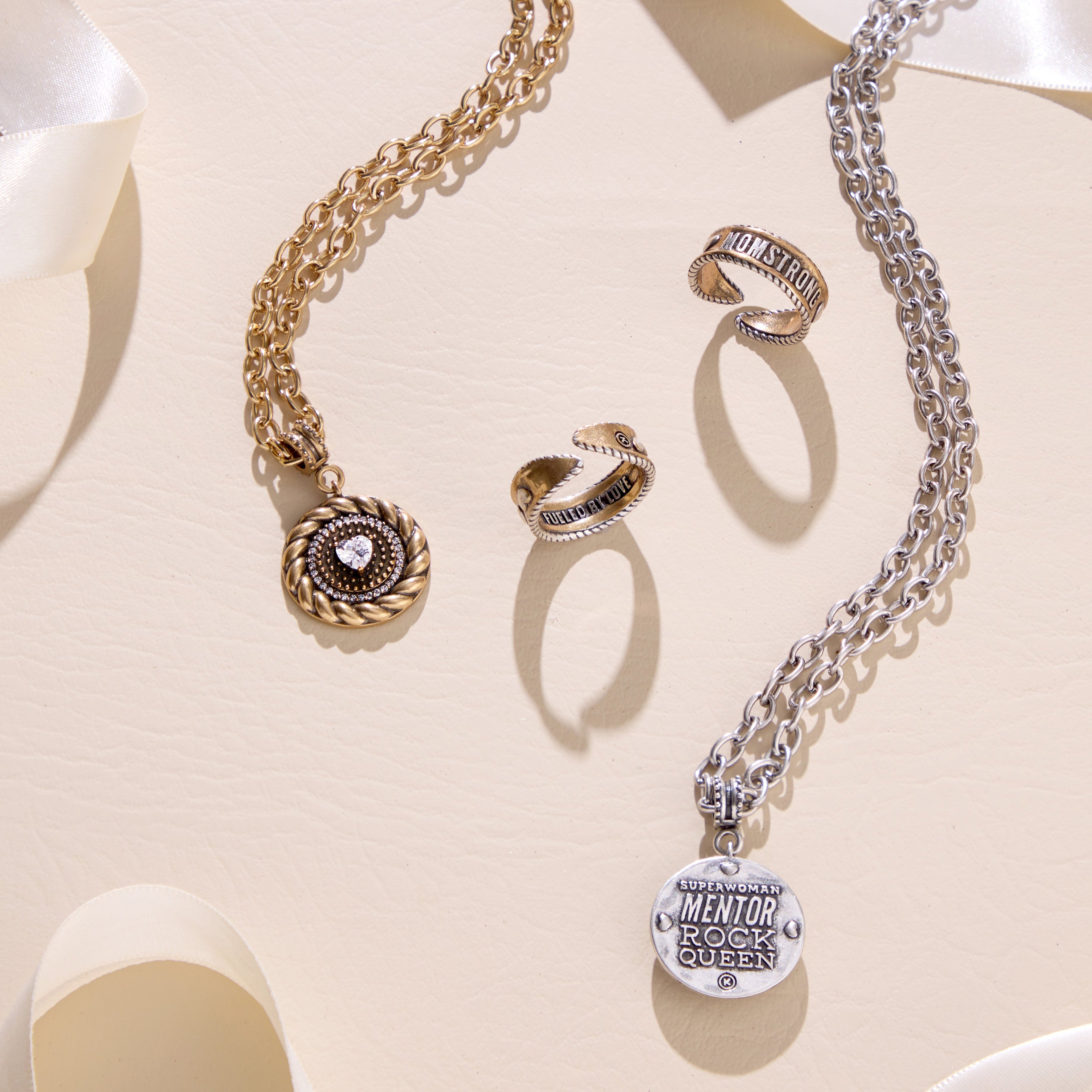 Katia Designs MomStrong adjustable ring featuring a sleek silver band and engraved "MomStrong" inscription.