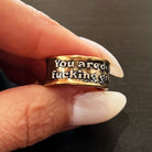 Katia Designs adjustable ring with engraved "You Are Doing F*cking Great Remember" message, featuring a sleek metal band.