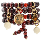 Katia Designs I Am Safe Heart wood boho wrap bracelet and necklace with antique gold accents, featuring a heart pendant.