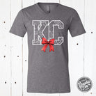 KC Delft Print with Bow V-Neck Tee, a stylish SS graphic tee from The Graphic Tee featuring a vibrant Delft-inspired print and bow detail.