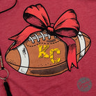 KC Football Bow Heather Cardinal short sleeve crewneck tee by The Graphic Tee, featuring a graphic football bow design in heather red color.