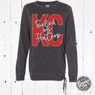 Mineral washed ladies lace-up sweatshirt by The Graphic Tee featuring bold "Fueled By Haters" print, casual and stylish shirt.