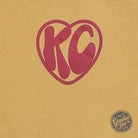 KC Groovy Mustard Comfort Colors long sleeve graphic tee with colorful retro design, casual fit, and soft fabric.