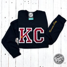 Black crewneck sweatshirt with red glitter applique design, from The Graphic Tee, featuring a stylish and casual look.