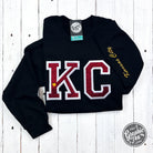 Black crewneck sweatshirt by The Graphic Tee with red glitter applique design on the front.