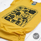 Heather golden yellow short sleeve graphic tee from The Graphic Tee with the phrase "Kind Words" printed on the front.