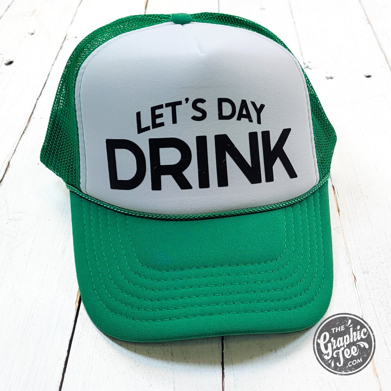 Let's Day Drink foam trucker cap in Kelly green and white by The Graphic Tee, featuring a classic trucker hat style.