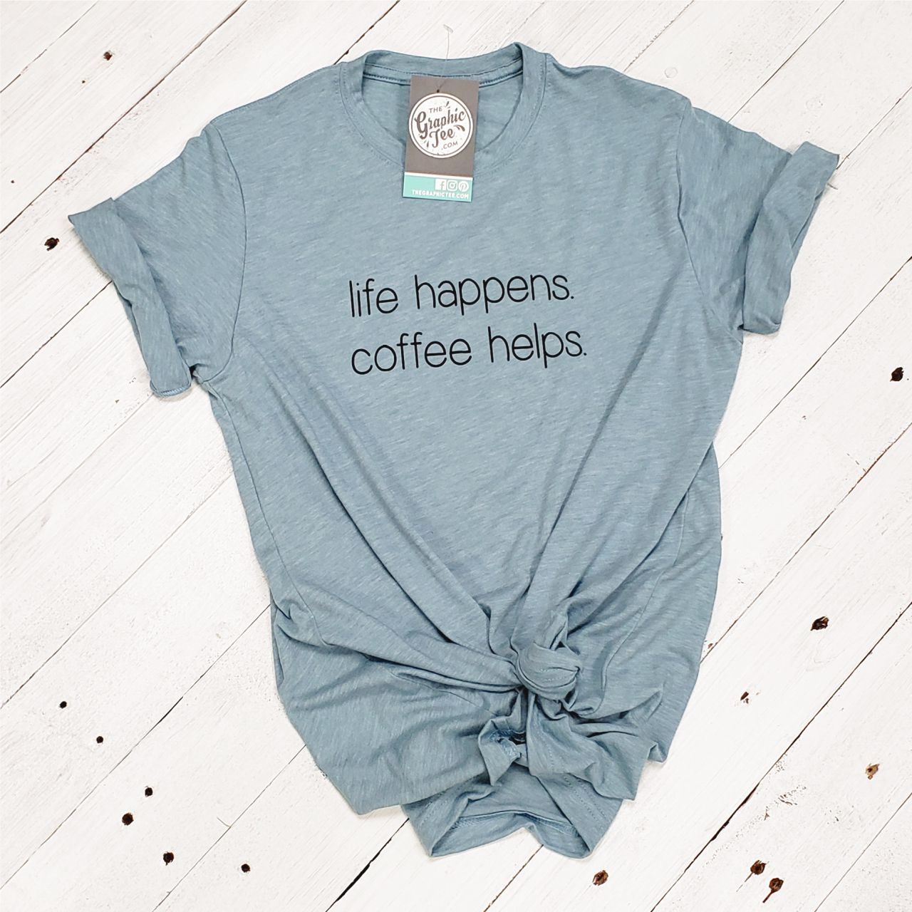 Unisex graphic T-shirt featuring the "Life Happens. Coffee Helps." design by The Graphic Tee, casual wear with printed text.