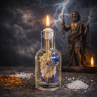 Zeus oil candle by Logos Candles featuring a sleek glass container with a lit wick and decorative metallic accents.