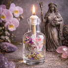 Elegant Logos Candles Rhea oil candle with a glass holder and lit wick, creating a warm, ambient glow.