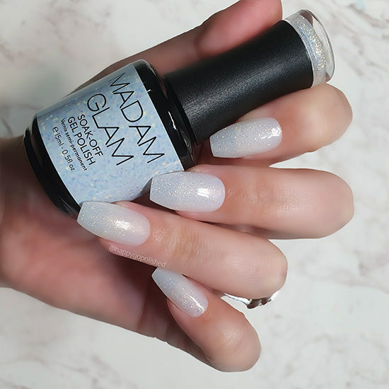 Madam Glam "Am I Clear?" nail polish bottle with clear glass and white cap, showcasing the transparent nail polish inside.