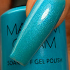 Madam Glam Aqua Shine nail polish bottle with vibrant turquoise color and shiny finish.