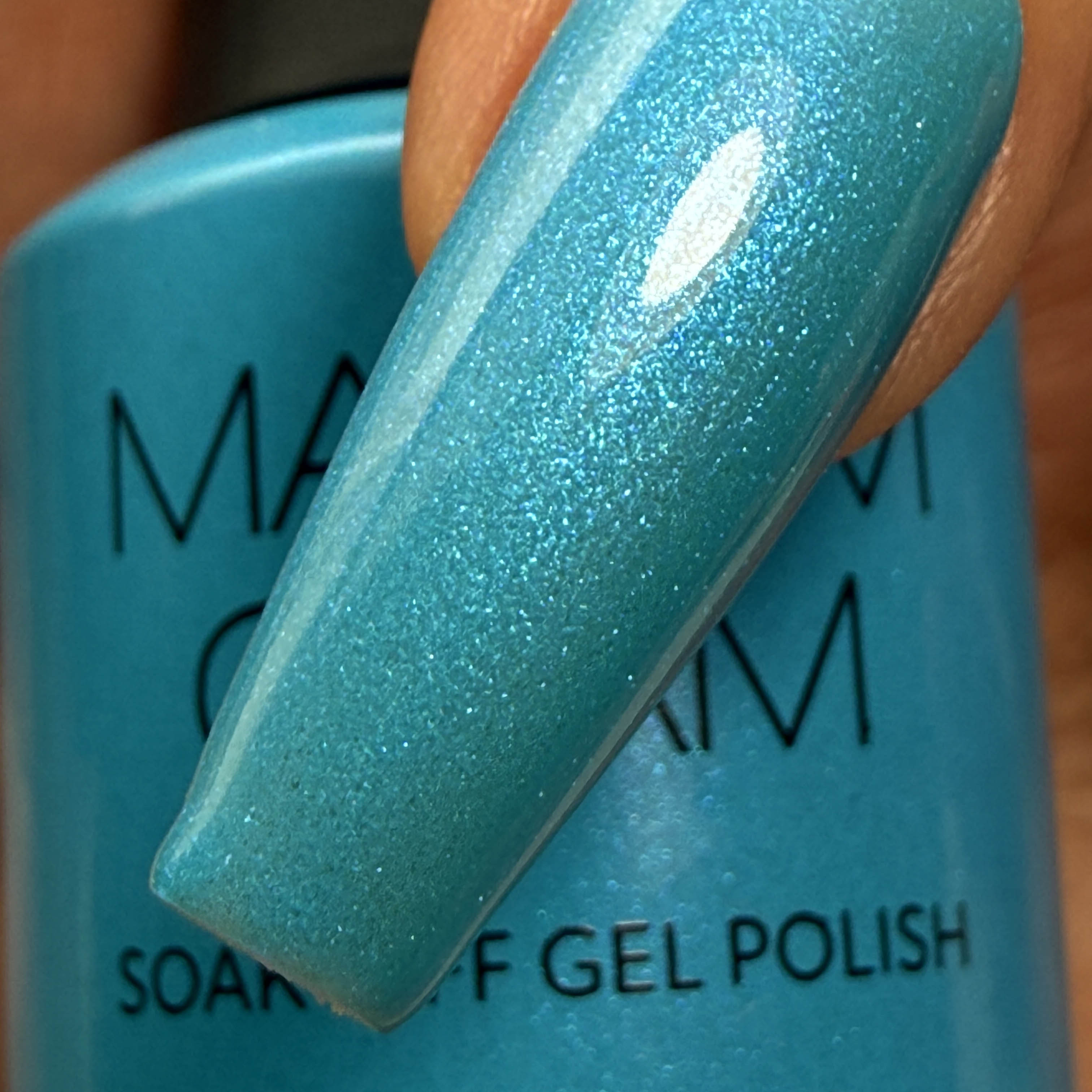 Madam Glam Aqua Shine nail polish bottle with vibrant turquoise color and shiny finish.