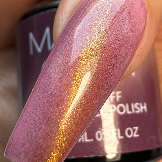 Madam Glam Golden Leaves nail polish with a shimmering gold leaf design on a clear background.