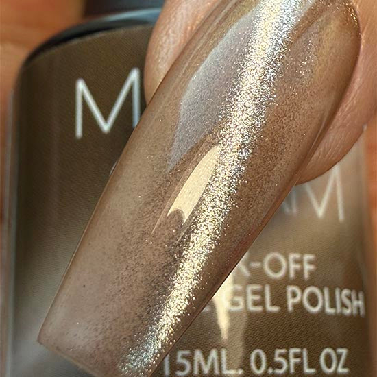 Madam Glam Harvest Glow nail polish bottle with the label visible, showcasing a vibrant, glowing orange shade.