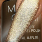 Madam Glam Harvest Glow nail polish bottle with a warm, glowing orange and gold shimmer finish.