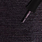 Madam Glam Haunted Velvet nail polish bottle with dark velvet finish and black cap, showcasing luxurious, deep purple color.