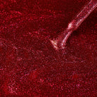 Madam Glam Heart Glow nail polish bottle with a heart-shaped cap, showcasing a pink and red glossy finish.