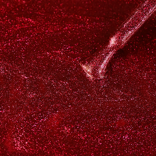 Madam Glam Heart Glow nail polish bottle with a heart-shaped cap, showcasing a pink and red glossy finish.