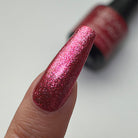 Madam Glam Heart Glow nail polish with a shimmering pink heart-shaped design on a clear base.