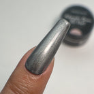 Holographic chrome gel paint by Madam Glam showing a shiny, iridescent finish on a nail surface.