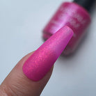 Madam Glam Rose Glitz nail polish bottle with a shimmering pink hue, showcasing the luxurious, glittery finish of the product.
