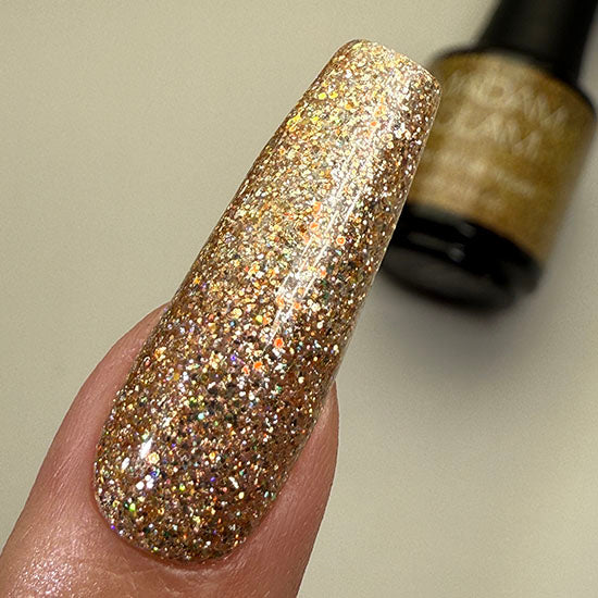 Madam Glam Santa's Treasure nail polish bottle with festive red and gold design, showcasing holiday-themed nail color.