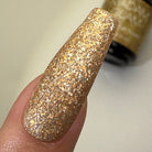 Madam Glam Santa's Treasure nail polish bottle with festive red and gold packaging, holiday-themed design, and brand logo visible.