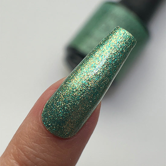 Madam Glam Shamrock Glow nail polish bottle with green shimmer finish, displayed against a neutral background.