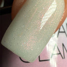 Madam Glam Shimmer Aurora nail polish bottle with iridescent, shimmering finish and colorful accents.