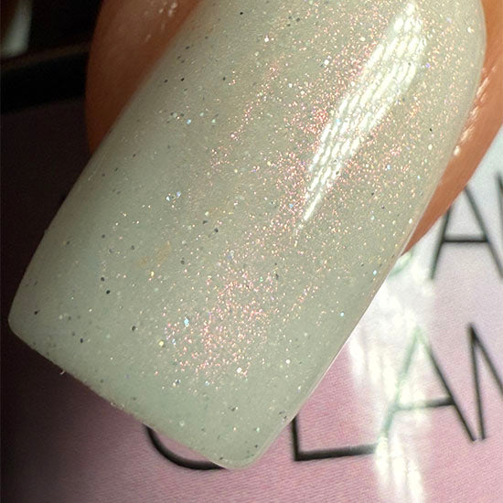 Madam Glam Shimmer Aurora nail polish bottle with iridescent, shimmering finish and colorful accents.