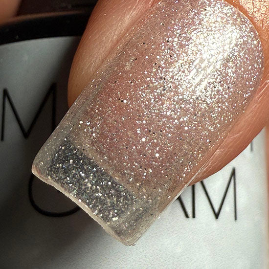 Madam Glam Shimmer Clear nail polish bottle with a shimmering, transparent finish and glossy cap.