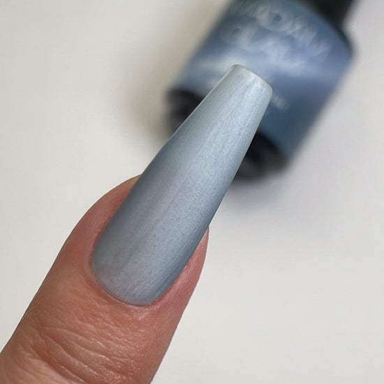 Madam Glam Sleepy Morning nail polish bottle with pastel pink and beige shades, displayed on a neutral background.