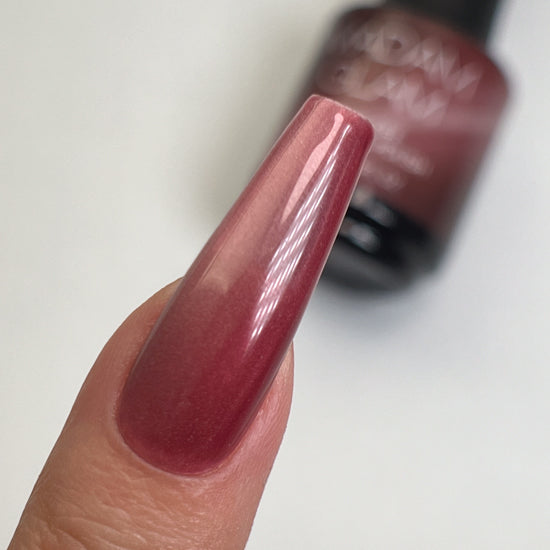 Madam Glam Sweet Merlot nail polish bottle with deep red color and brand label, showcasing the product's elegant packaging.