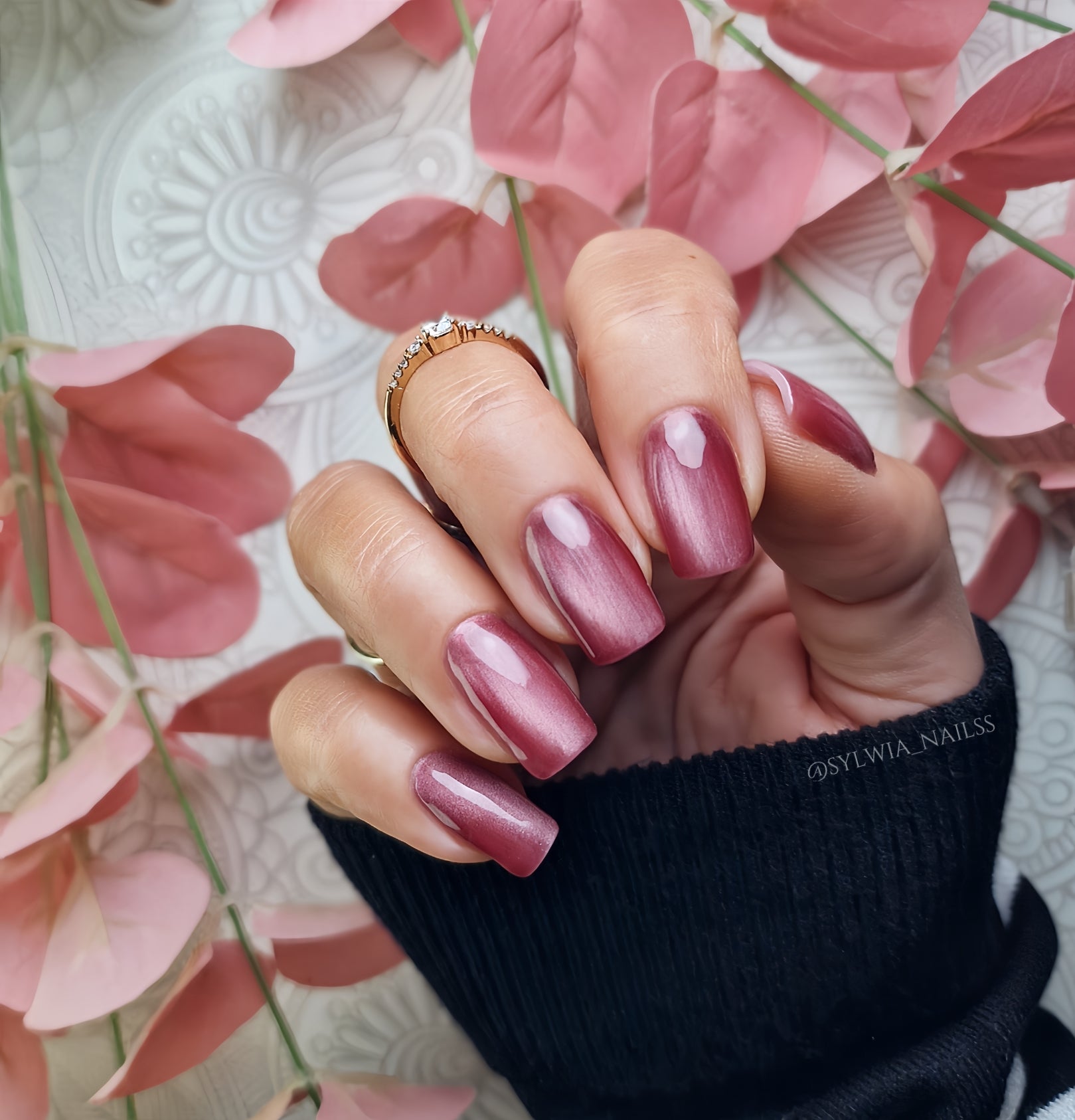 Bottle of Madam Glam Sweet Merlot nail polish with a deep red color, featuring the product label and cap visible.