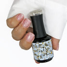 Madam Glam Touches of Gold nail polish bottle with gold accents and label, showcasing elegant nail color and packaging.