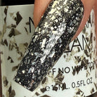 Madam Glam Touches of Silver nail polish bottle with silver-colored cap and label, showcasing a sleek, modern design.